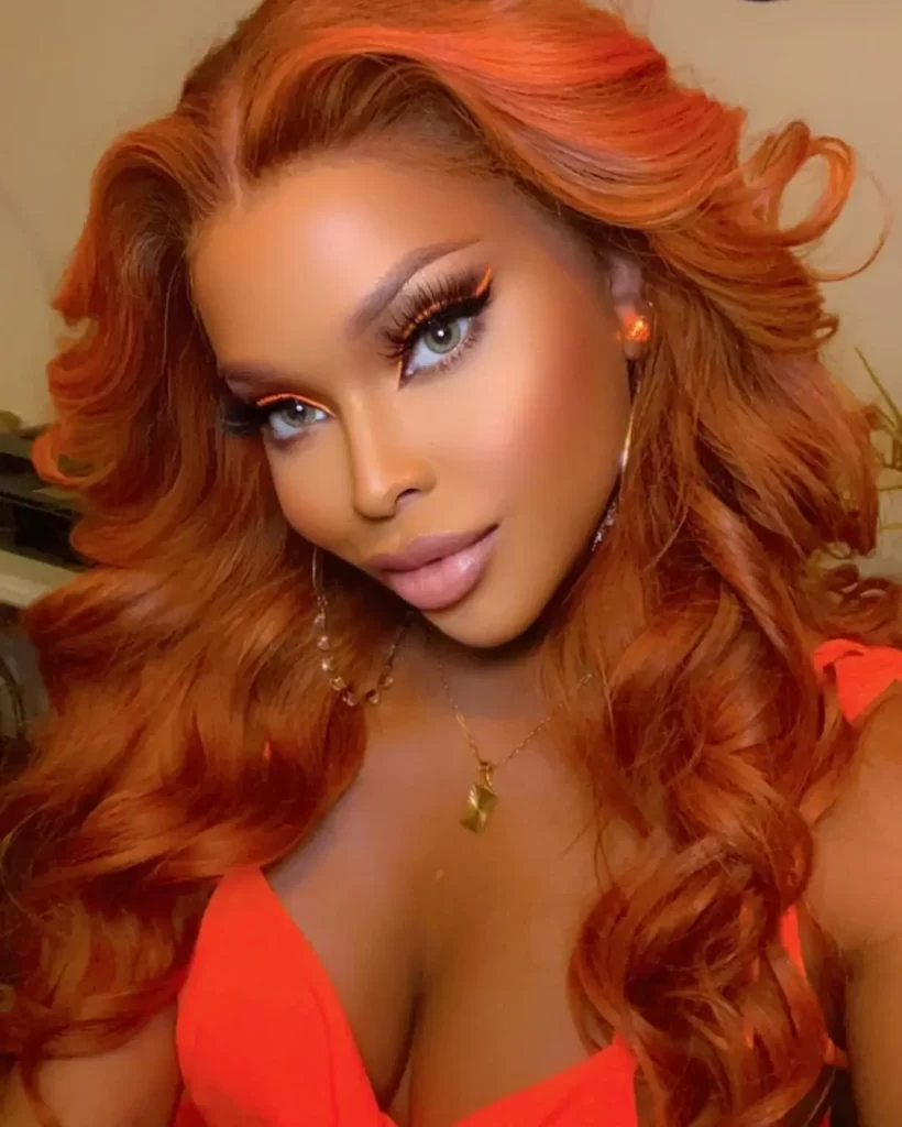 Amiyah Scott with red hair and glamorous makeup.