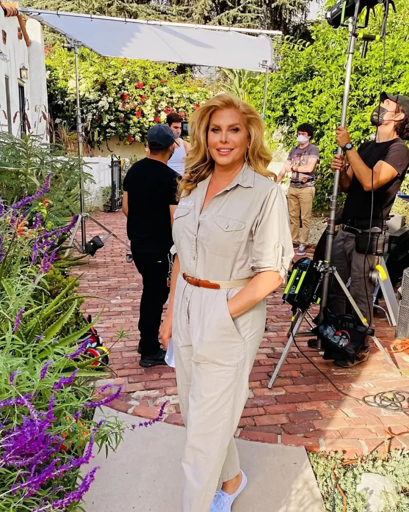 Candis Cayne on film set with crew and equipment.