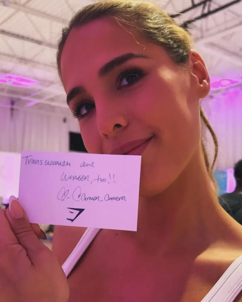 Carmen Carrera holding a supportive trans rights message.