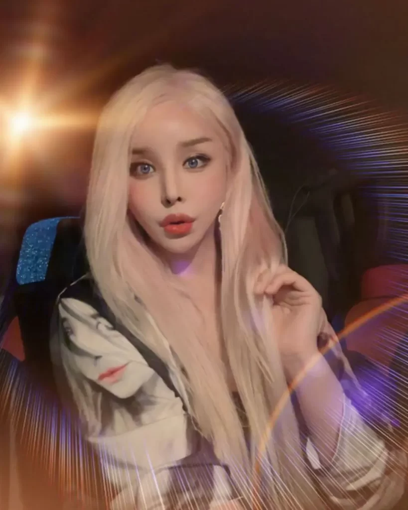 Harisu with blonde hair, light effects, and printed shirt.
