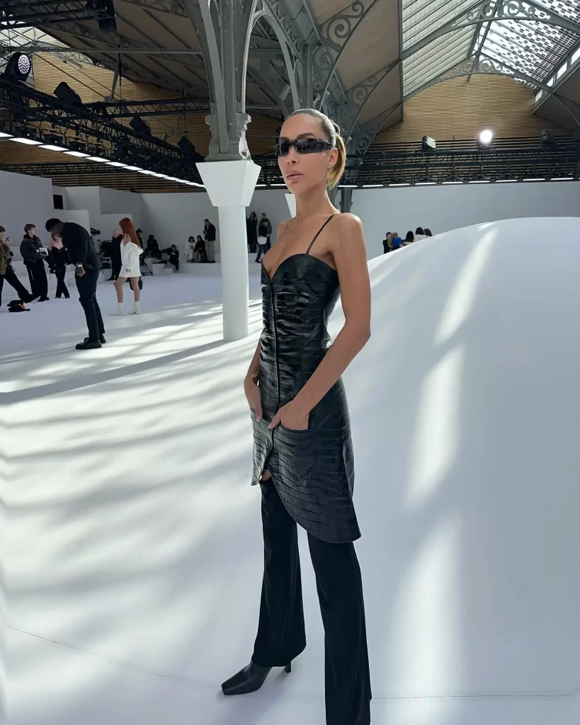Ines Rau in chic attire at fashion event.