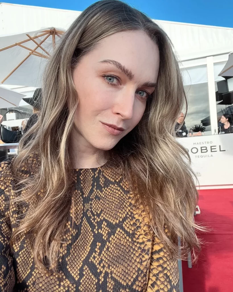 Jamie Clayton at event, patterned dress, outdoor selfie.