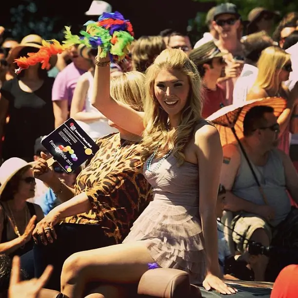 Jenna Talackova celebrating at outdoor festival with crowd.