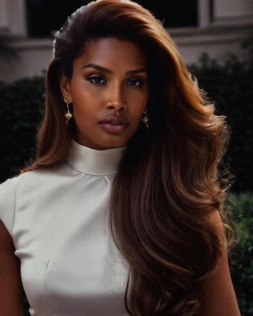 Leyna Bloom with elegant hairstyle and white dress outdoors.
