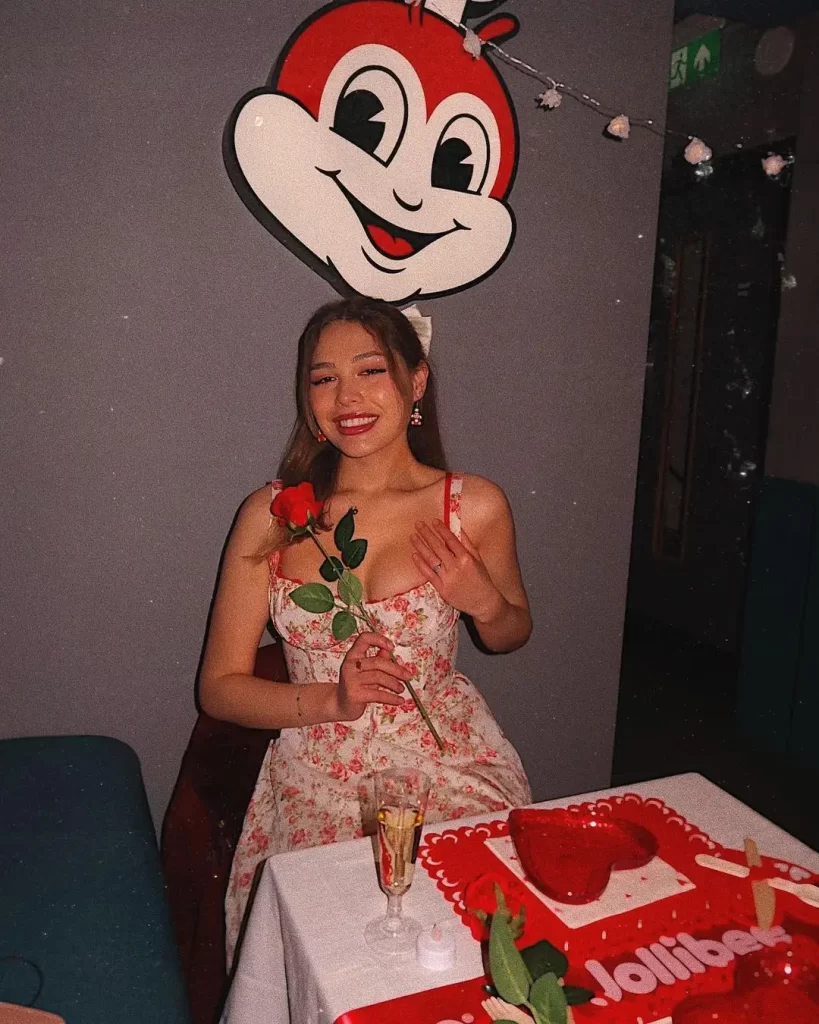 AJ Clementine celebrating with cake at Jollibee-themed party.