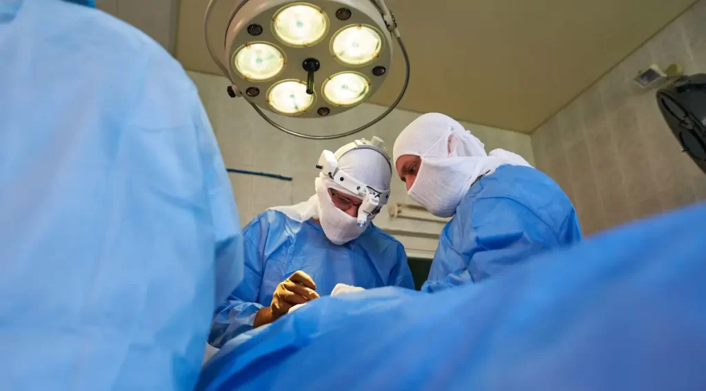 bottom up view faces surgeons round surgical lamp